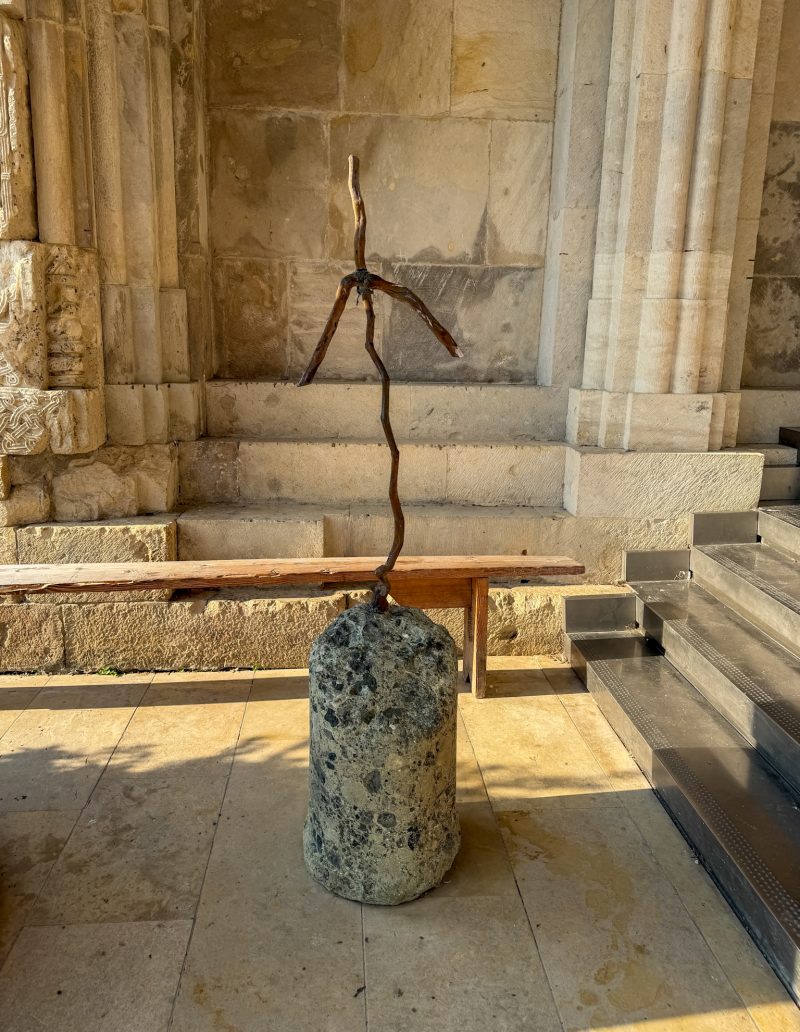 Grapevine cross of St. Nino on a stone base at the entrance of Bagrati Cathedral