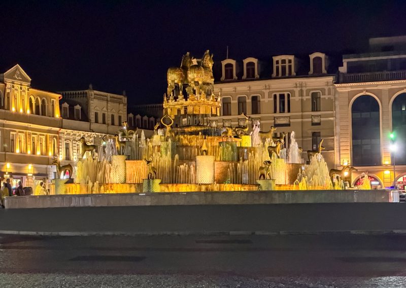 Colchis Fountain lit up in gold at night in the main square of Kutaisi, Georgia